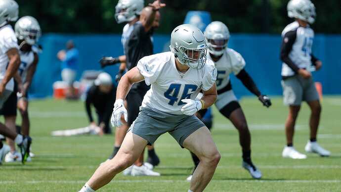 Malcolm Rodriguez and Jack Campbell of the Detroit Lions tackle